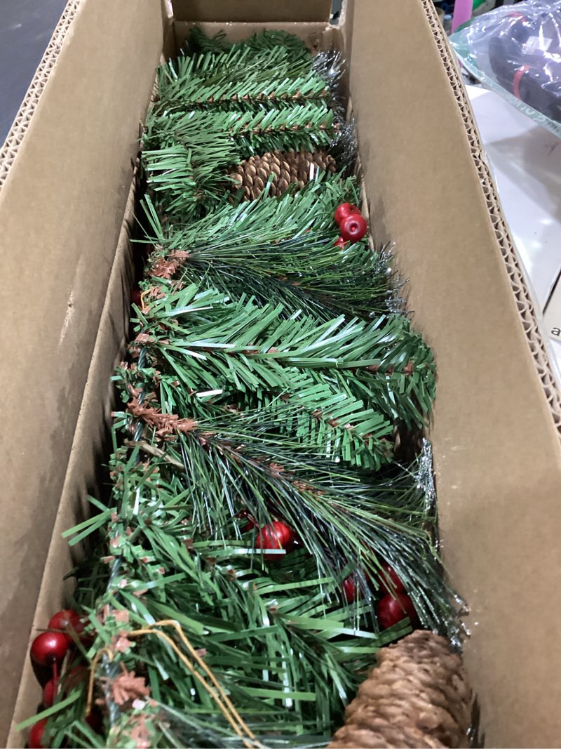 Condition photo showing New/Like New for national tree company 9 ft pre-lit crestwood spruce artificial christmas garland, christmas decoration with glitter, pinecones, red berries, 50 clear lights, 180 tips, green plug in tree