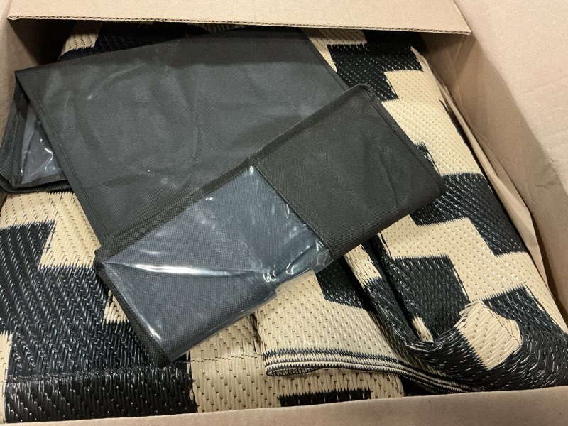 Condition photo showing Good Condition for Smiry Waterproof Outdoor Rug 9x12 ft, Reversible Plastic Straw Patio Camping Rugs, Outdoor Indoor RV Mat Carpet for Patio, Outside Entry, Backyard, Deck, Bench, Picnic, Camper, Black & Beige Black and Beige 9' x 12' (Rectangular)