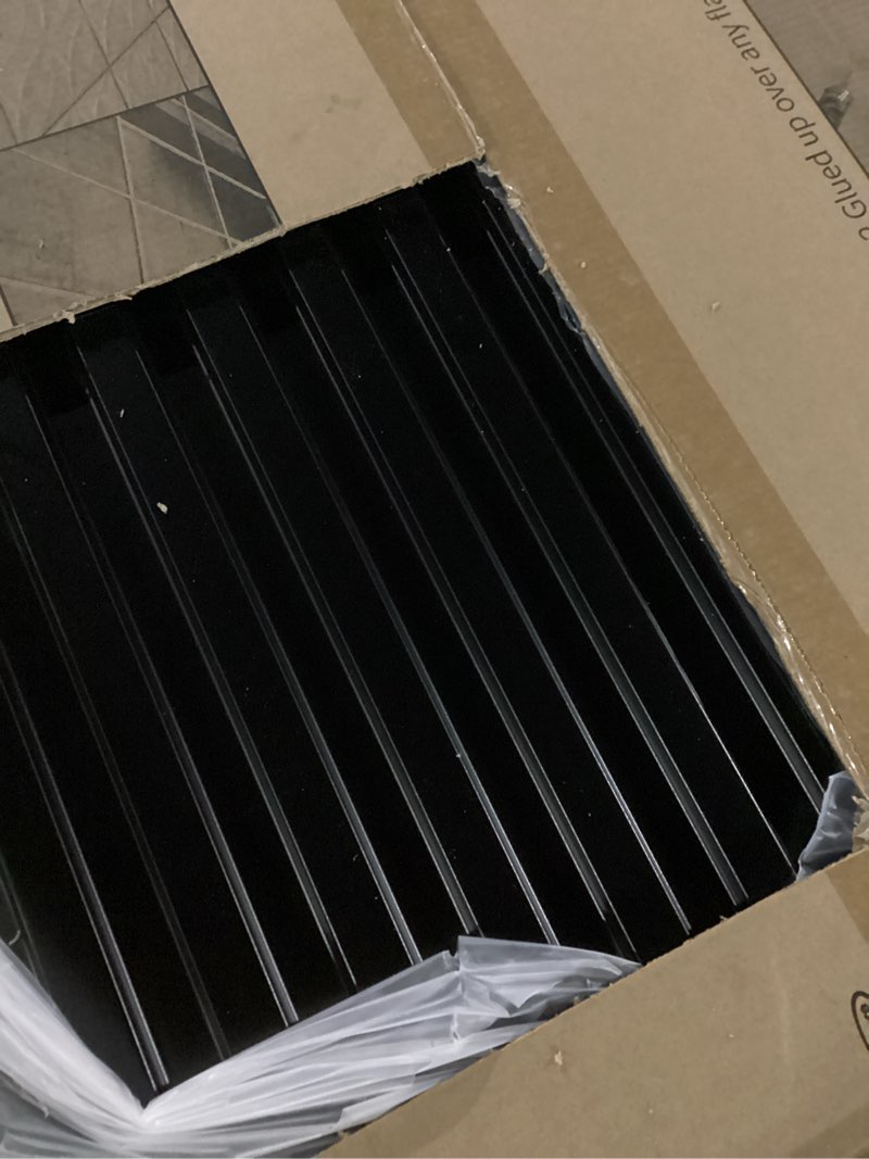 Condition photo showing As Is for Art3d 12-Pack Slat Design 3D Wall Panels for Interior Wall Decor, 2x4 FT PVC Decorative Drop Ceiling Tiles - Black 24 x 48in. Oblong - Black 12