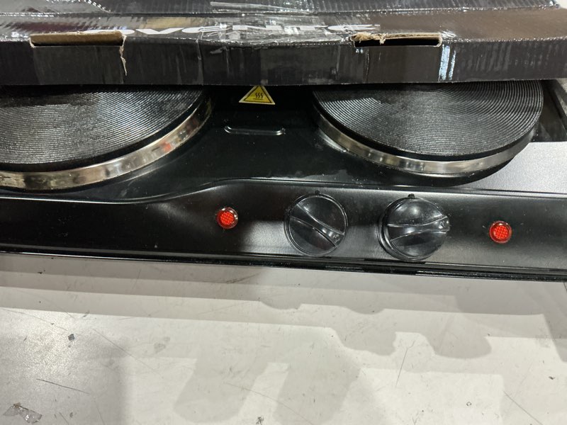Condition photo showing As Is for ovente electric countertop double burner, 1700w cooktop with 7.25" and 6.10" cast iron hot plates, temperature control, portable cooking stove and easy to clean stainless steel base, black bgs102b bgs102b - black