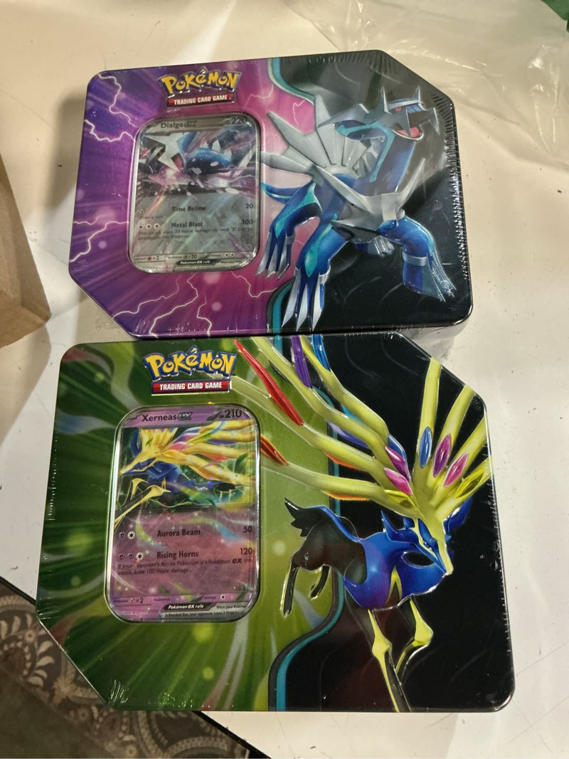 Condition photo showing New/Like New for pokemon tcg: azure legends tin - 5 packs (random tin) 2 random tins