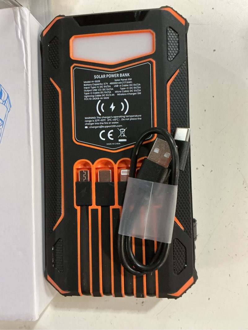 Condition photo showing New/Like New for soaraise solar charger power bank - 48000mah wireless portable charger built-in 4 cables and 4 solar panels, pd qc 3.0 fast charging usb c battery pack with flashlight for camping travel orange