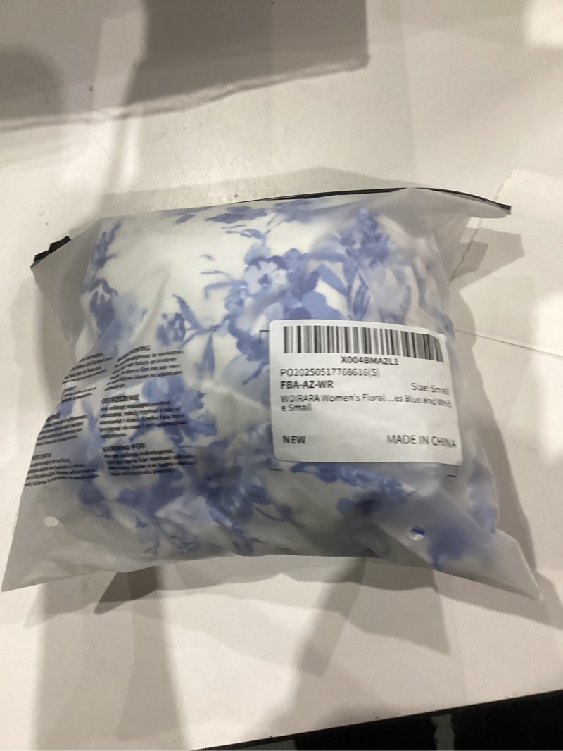 Condition photo showing New/Like New for WDIRARA Women's Floral Print Cut Out V Neck Cami Dress Boho Tie Back Flared Midi Dresses Small Blue and White