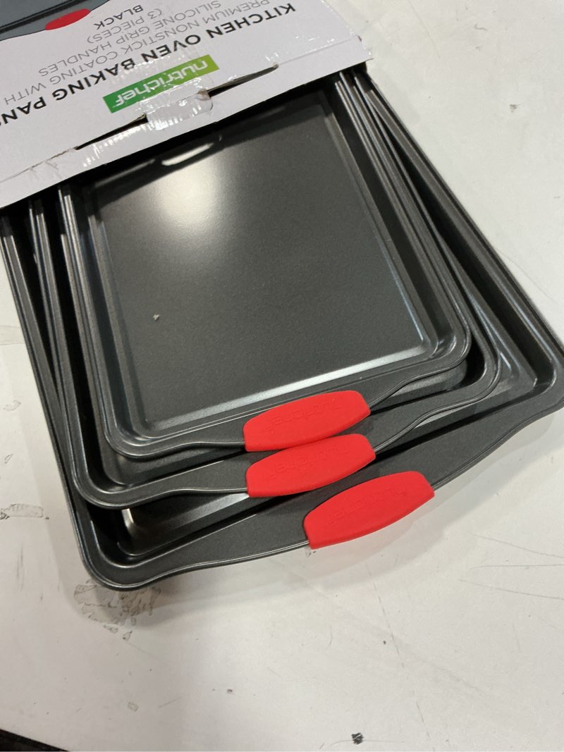 Condition photo showing Good Condition for NutriChef 3-Piece Nonstick Kitchen Oven Baking Pans - Premium & Stylish Non-Stick Steel, Commercial Grade Restaurant Quality Metal Bakeware with Red Silicone Handles - Easy to Clean, NCSBS3S 3-Piece Set