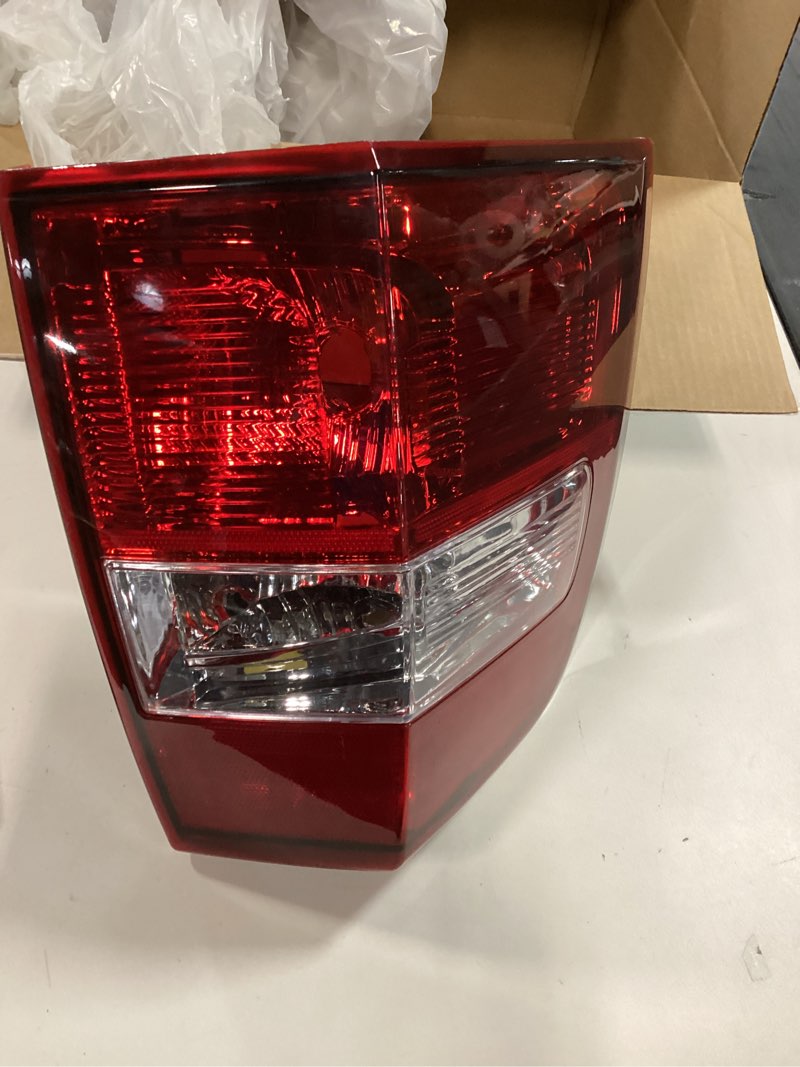 Condition photo showing As Is for Replacement Passenger Side Tail Light, without Bulb, Halogen, Clear and Red Lens