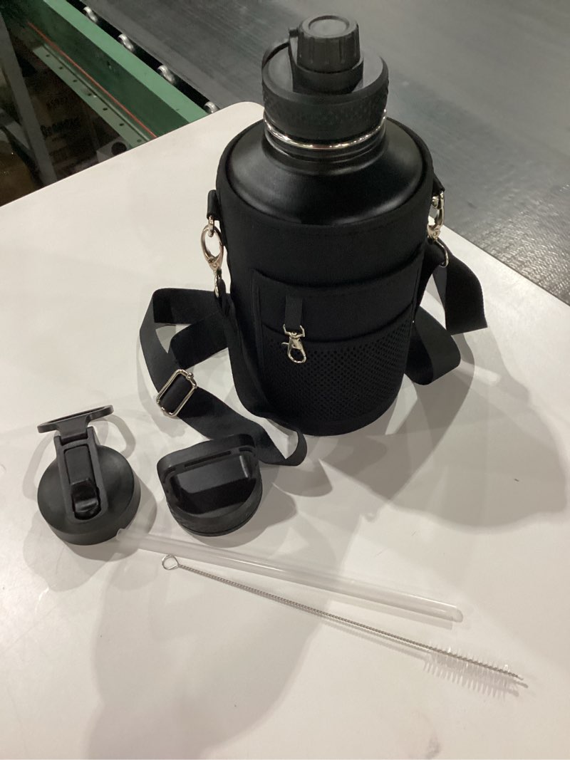 Condition photo showing Good Condition for 64 oz Water Bottle Insulated with Straw & 3 Lids, Coolflask Large Metal Stainless Steel Water Jug Big Half Gallon Wide Mouth for Sports, Gym or Office, Non-BPA Keep Cold 48H Hot 24H, Magic Black 64 Ounces Magic Black