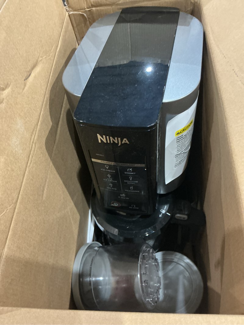 Condition photo showing As Is for ninja nc301 creami ice cream maker, for gelato, mix-ins, milkshakes, sorbet, smoothie bowls & more, 7 one-touch programs, with (2) pint containers & lids, compact size, perfect for kids, silver