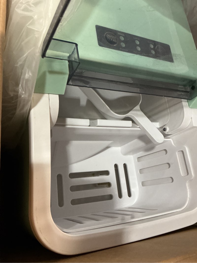 Condition photo showing As Is for newbulig ice makers countertop with handle, portable ice machine, 9 bullet ice cubes in 6 mins, 26lbs in 24hrs, auto-cleaning, with basket and scoop, for home, kitchen, rv, camping,green green 12.3"*11.5"*8.5"
