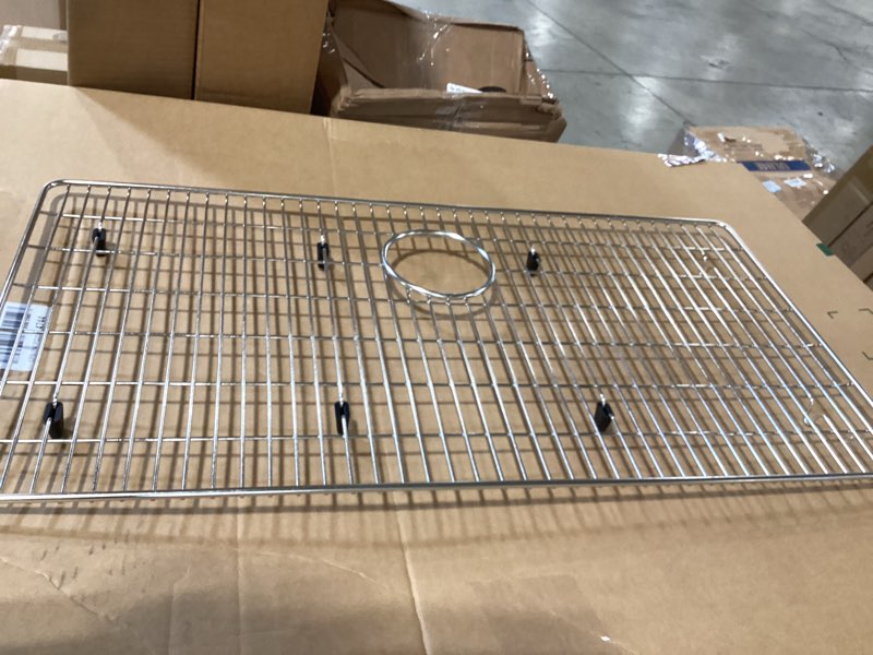Condition photo showing As Is for stainless steel sink protector 28-3/8" x 14-3/16" with rear drain, metal sink rack for bottom of sink, kitchen sink grate and sink protectors with sink strainer (28-3/8" x 14-3/16" - rear drain) detachable - 28-3/8" x 14-3/16" - rear drain