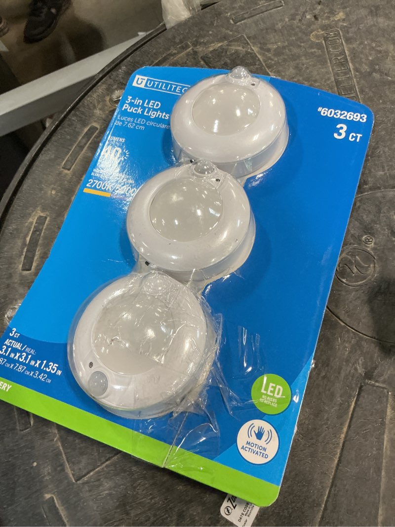 Condition photo showing As Is for utilitech 3-pack 1.35-in battery operated indoor led puck light with motion sensor