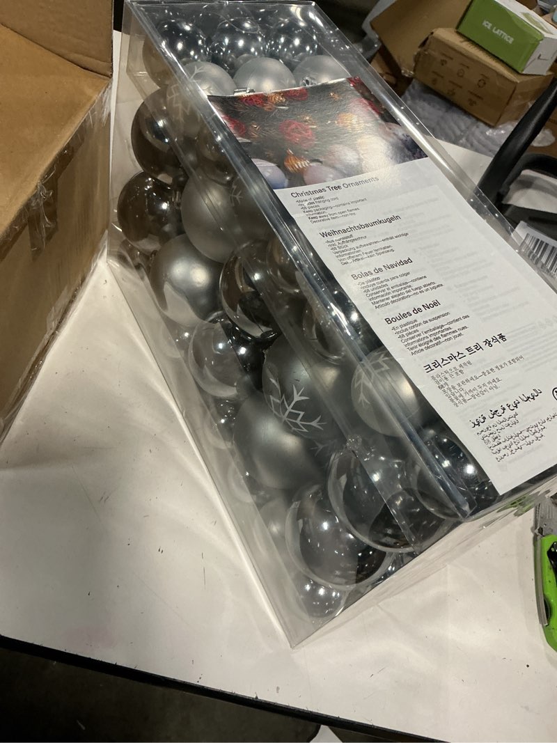Condition photo showing New/Like New for 68-piece set of silver christmas tree ornaments made of plastic