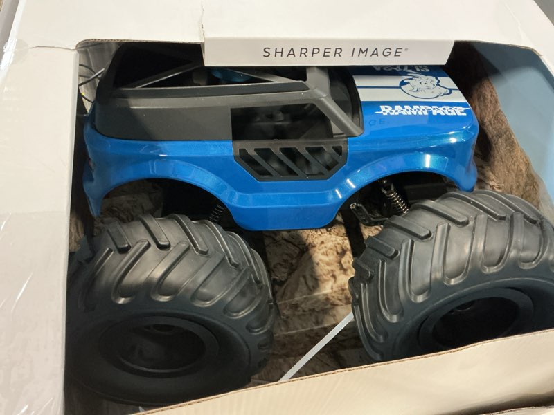 Condition photo showing As Is for sharper image® rampage renegade remote control off-road truck, all-terrain driving with full-control steering & oversized tires