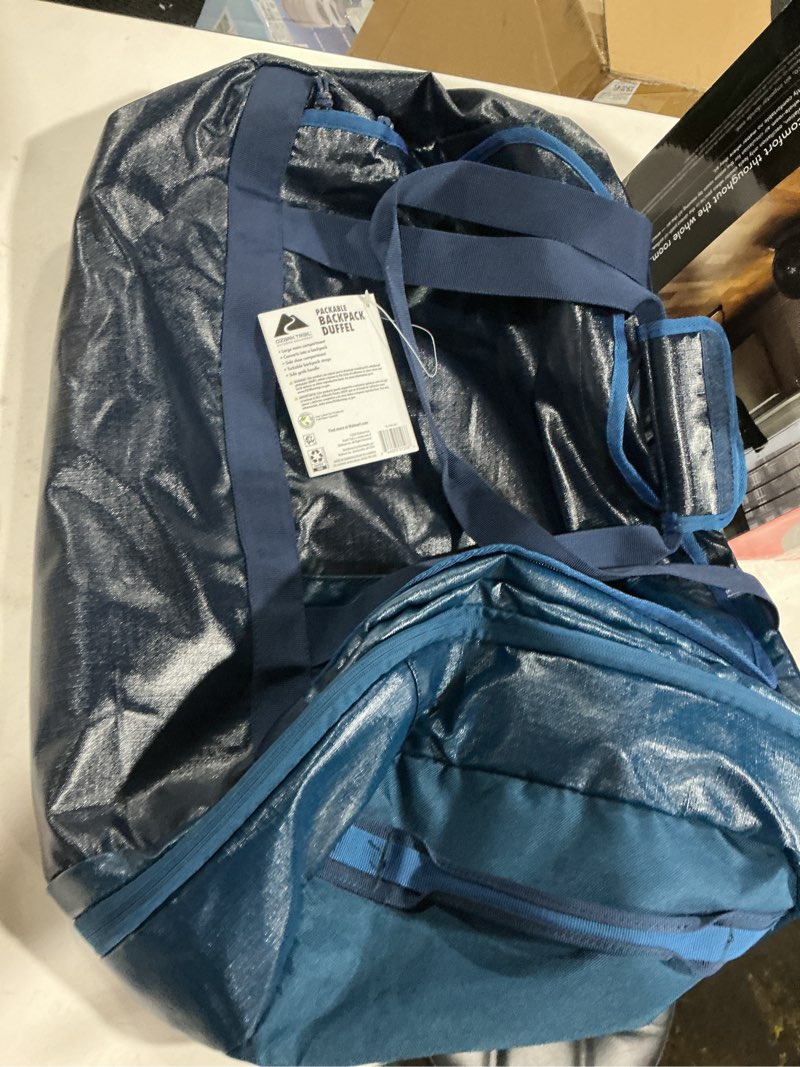 Condition photo showing Good Condition for ozark trail 70 ltr coated polyester ripstop duffel, with tuckable backpack straps, blue