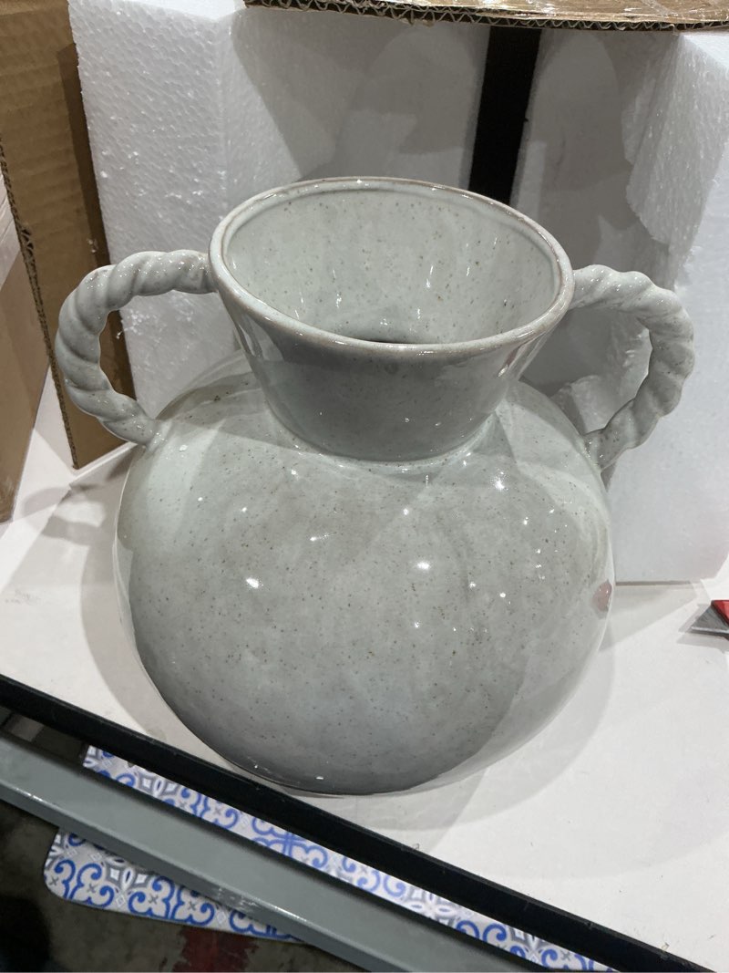 Condition photo showing Good Condition for 9.25 inches stoneware vase with twisted handles and reactive glaze, cream color