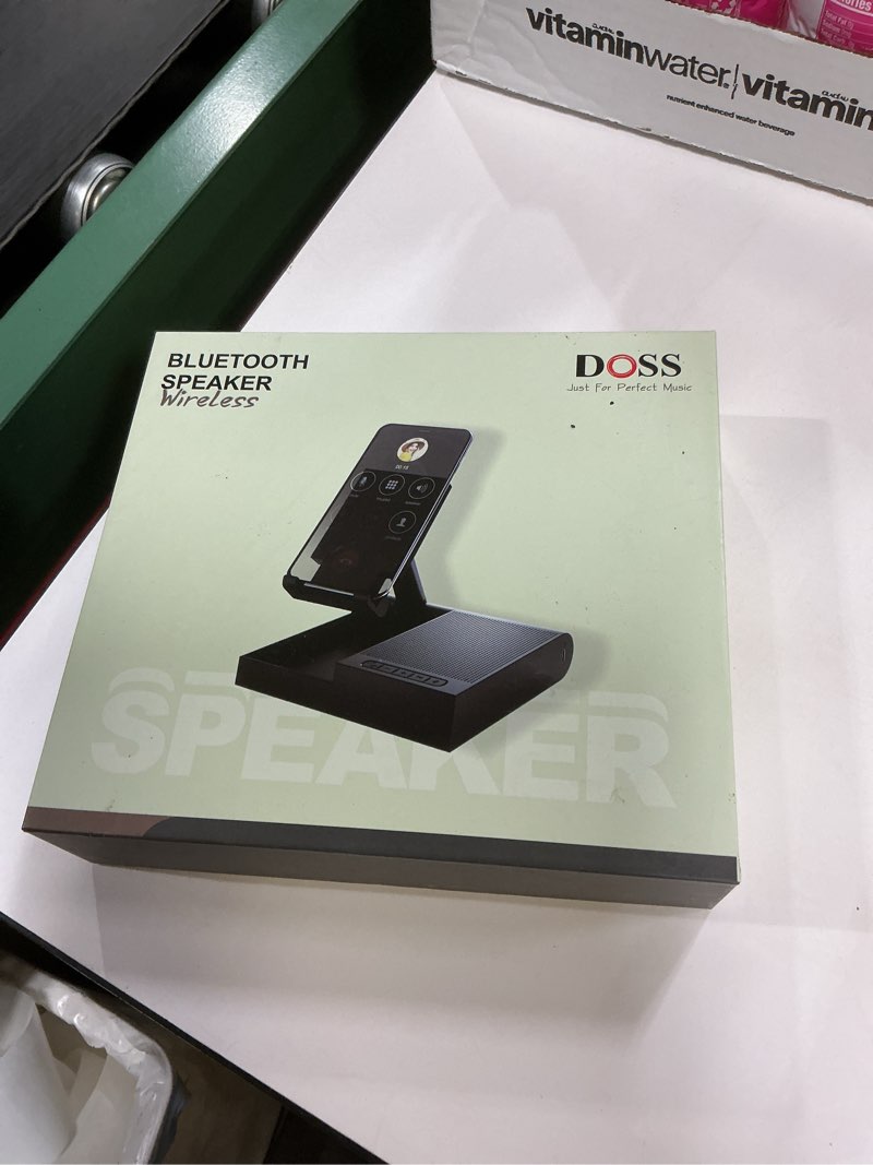 Condition photo showing New/Like New for DOSS Cell Phone Stand with Bluetooth Speaker, 15W Wireless Charger and Anti-Slip Base,4-in-1 Function, 8H Playtime, Hands-Free, Adjustable Holder, Compatible with Tablet