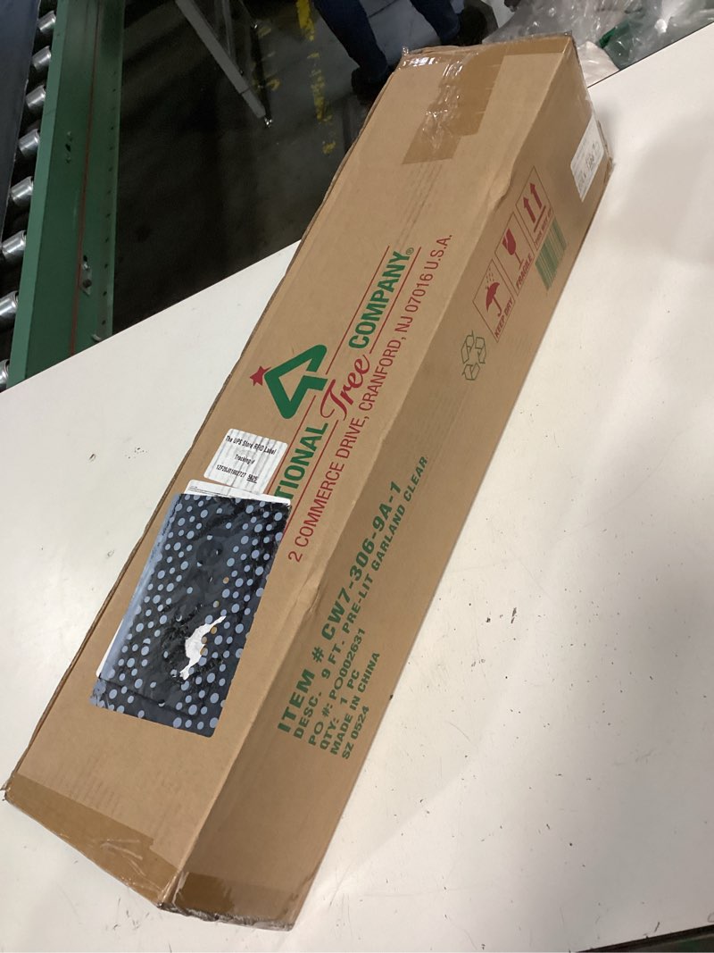 Condition photo showing New/Like New for national tree company 9 ft pre-lit crestwood spruce artificial christmas garland, christmas decoration with glitter, pinecones, red berries, 50 clear lights, 180 tips, green plug in tree