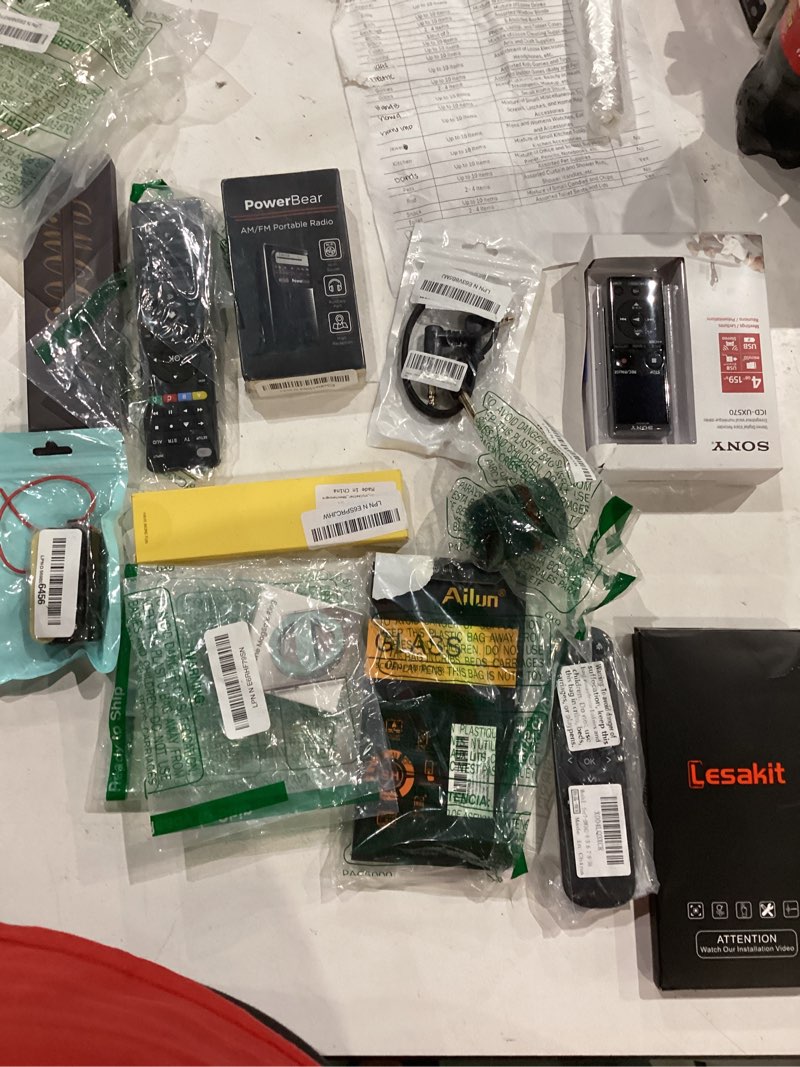 Condition photo showing As Is for assorted lot of electronics (headphones, small gadgets, headsets, etc.) 