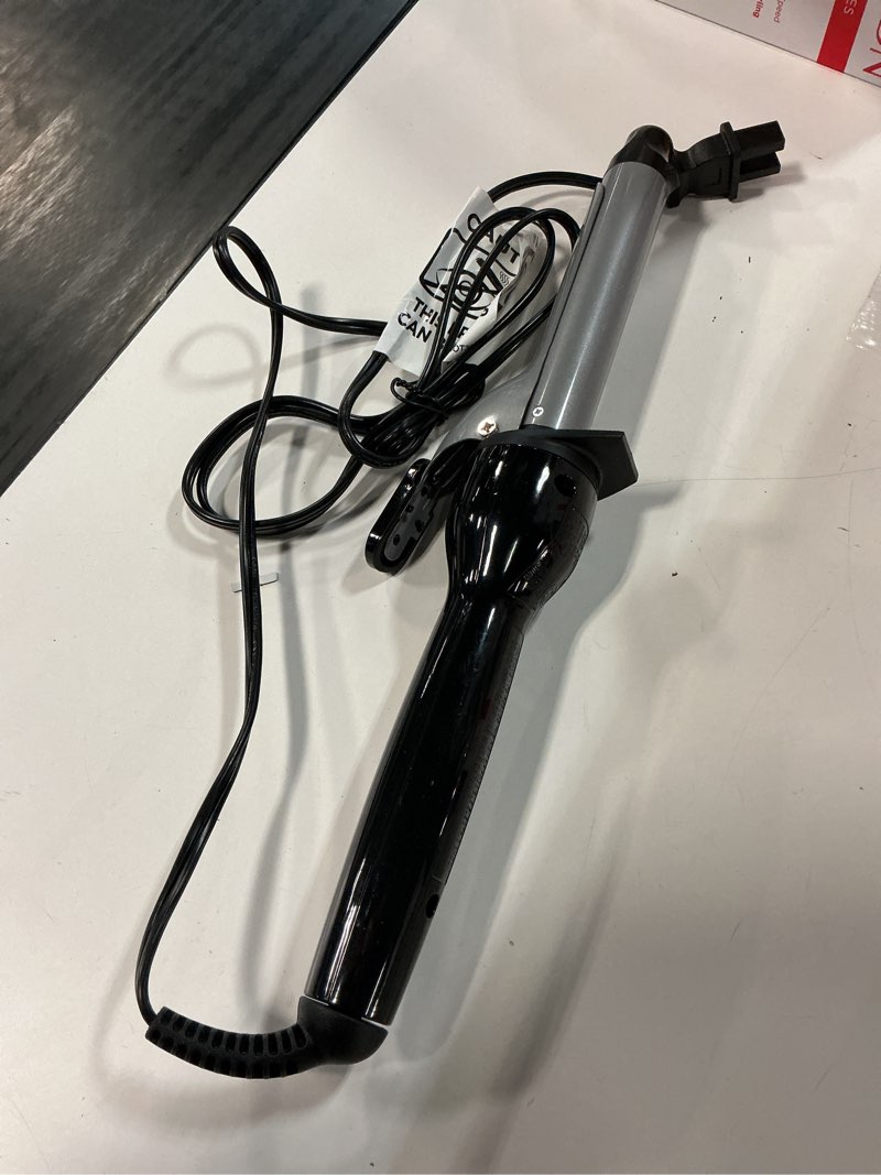 Condition photo showing As Is for revlon curling iron