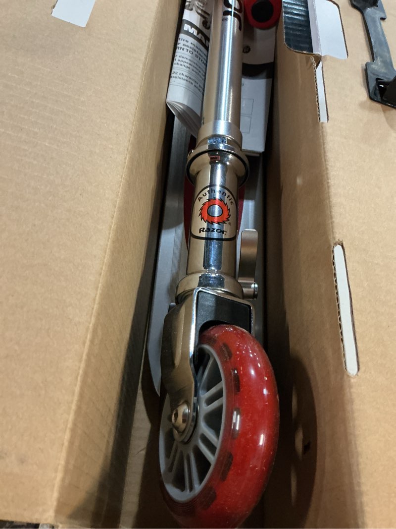 Condition photo showing New/Like New for razor a3 kick scooter for kids ages 5+ - larger wheels, front suspension, wheelie bar, lightweight, foldable, aluminum frame, and adjustable handlebars red