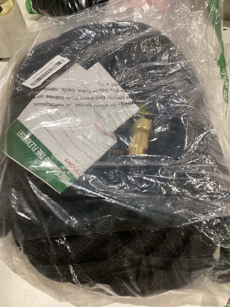 Condition photo showing As Is for flexi hose lightweight expandable garden hose, 150ft -retractable garden hose, water hose - no-kink flexibility, 3/4 inch solid brass fittings and double latex core black 150 ft