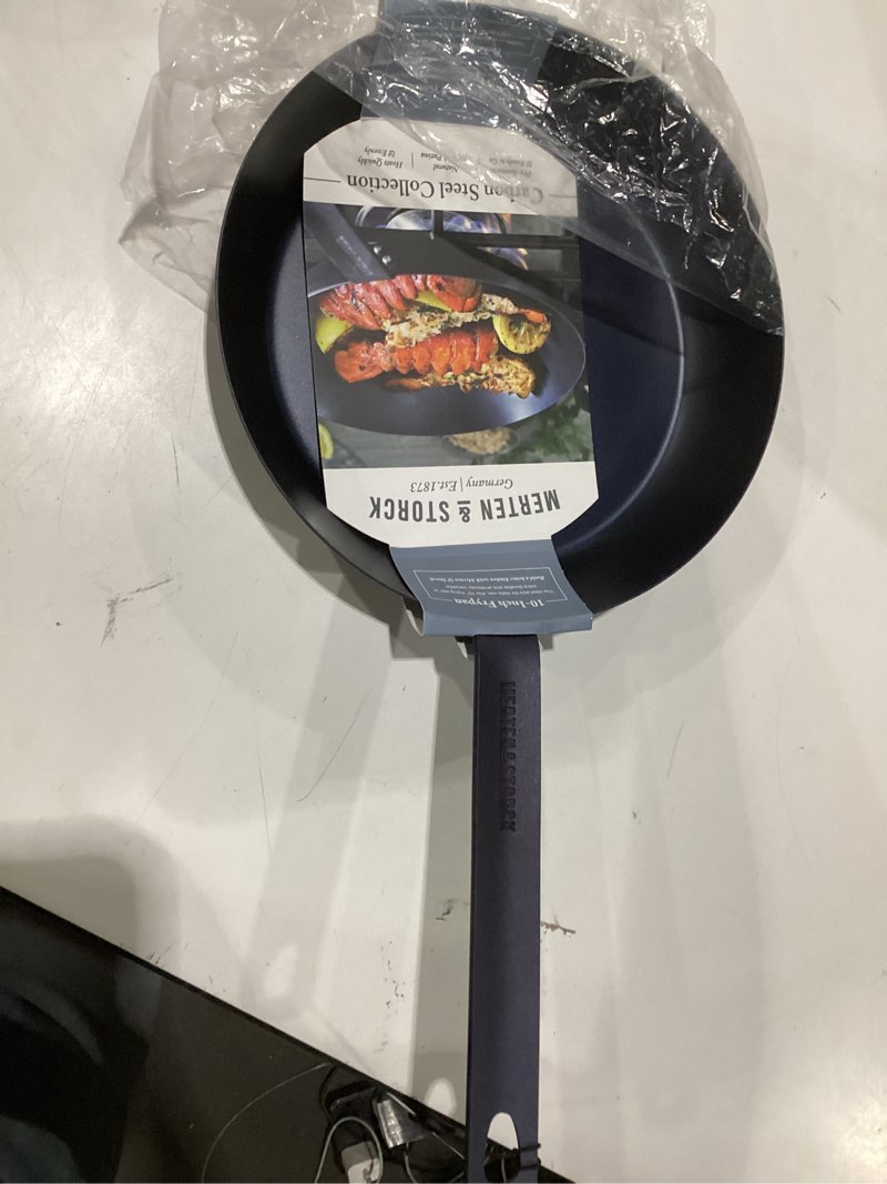 Condition photo showing New/Like New for merten & storck pre-seasoned carbon steel 10” frying pan skillet, use on induction, stove and grill, durable, even-heating, for searing, grilling, oven use, and campfire, indoor/outdoor 10" frying pan skillet black