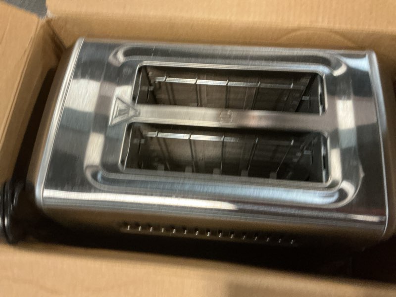 Condition photo showing As Is for hamilton beach 2 slice toaster with extra-wide slots, bagel setting, toast boost, slide-out crumb tray, auto-shutoff & cancel button, defrost function, stainless steel (22794) defrost function stainless steel toaster