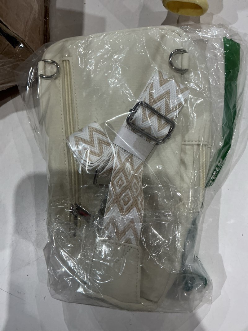 Condition photo showing As Is for similar to not exact . cream/white color sling bag with a patterned adjustable strap.