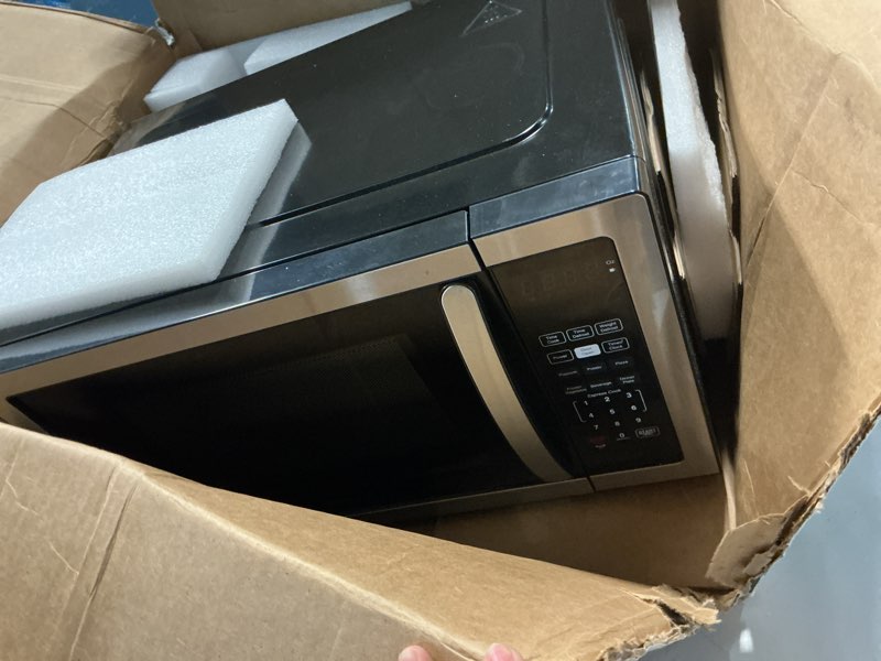 Condition photo showing As Is for farberware 1.1-cu ft 1000 -watt countertop microwave ( stainless steel/black )