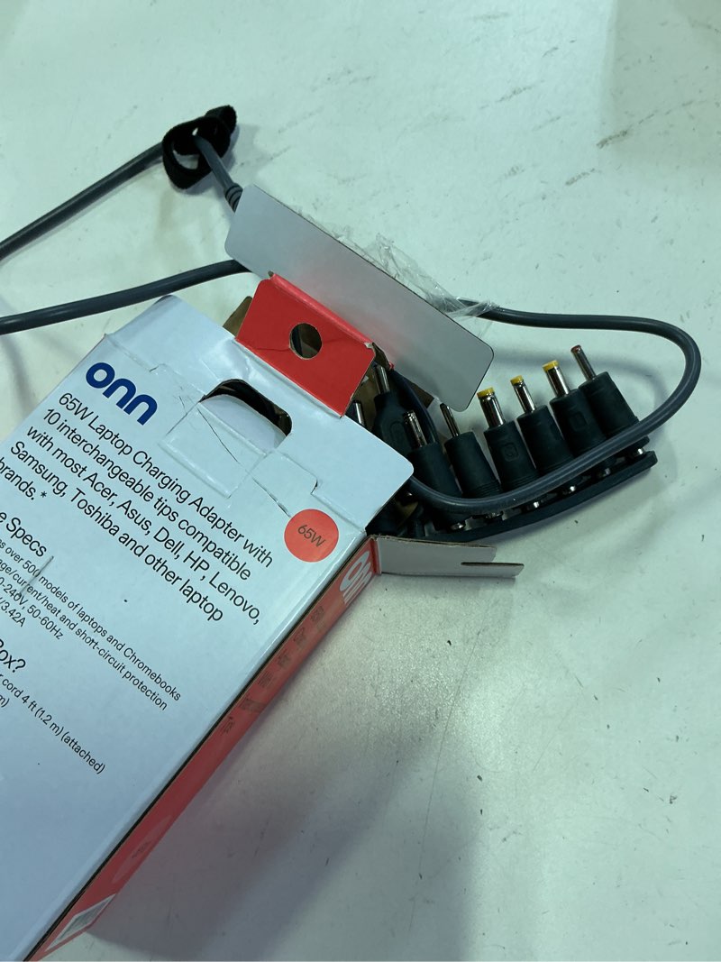 Condition photo showing As Is for onn. 65w laptop charger w/10 interchangeable tips, 10 ft power cord for hp, dell, lenovo laptops