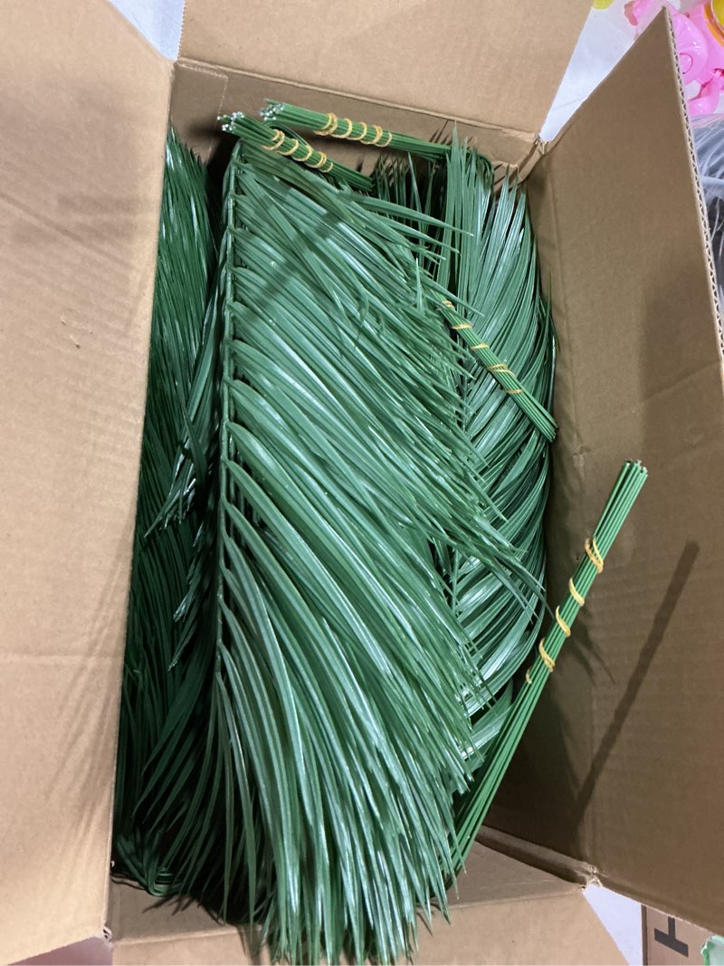 Condition photo showing Good Condition for Jutom 100 Pcs 25 Inch Artificial Palm Leaves Decor Large Tropical Faux Plants Plastic Fronds Fake Palm Branches Tree Leaves for Sunday Tree Vase Jungle Beach Party Wedding Decoration