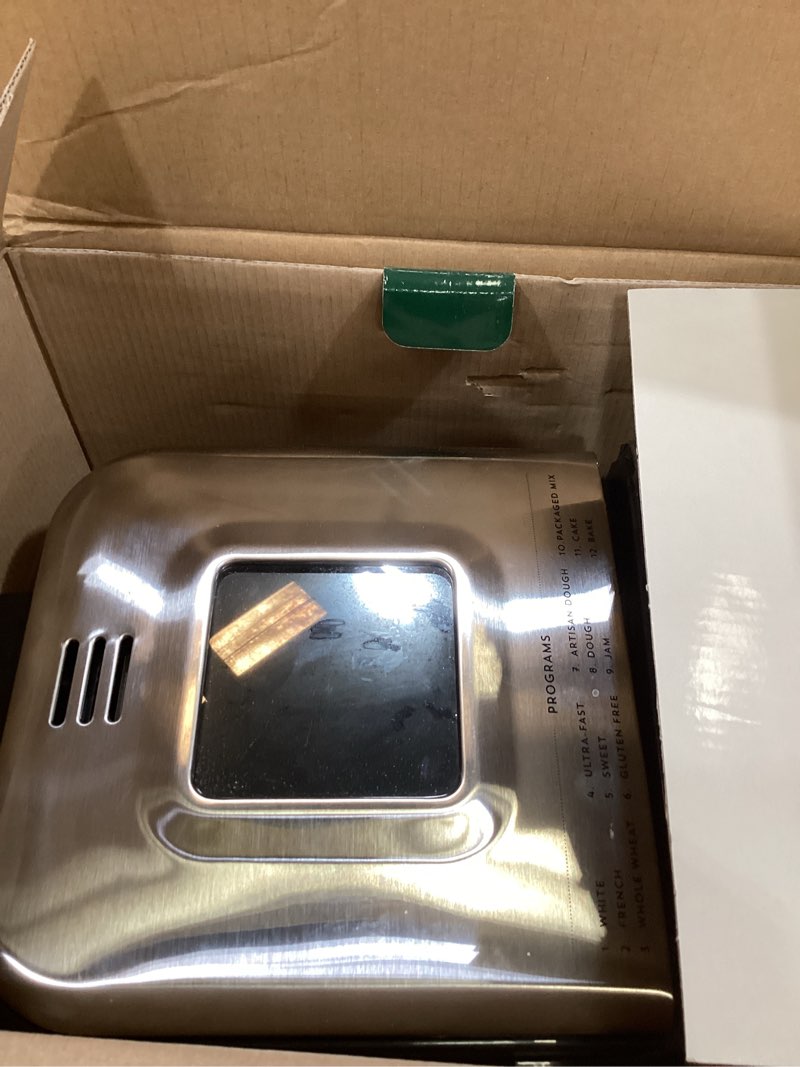 Condition photo showing As Is for cuisinart bread maker machine, stainless steel automatic bread machine with 12 menu options, 3 loaf sizes up to 2 lb., 3 crust colors, removable nonstick baking pan & kneading paddle, cbk-110nas