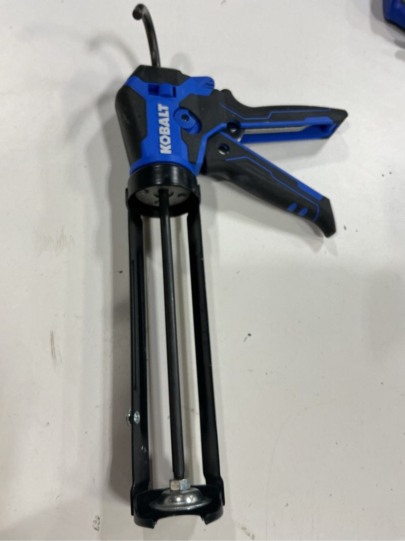 Condition photo showing As Is for kobalt dual thrust 10 -oz anti-drip smooth rod caulk gun