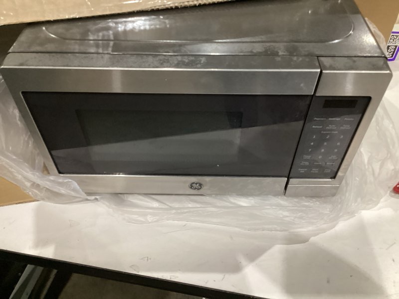 Condition photo showing As Is for ge 4-in-1 countertop microwave oven, 1.0 cu ft, 1050w convection microwave with air fry & broil, compact and quiet, stainless steel, ideal for apartments, dorms & offices, gcst10a1wss
