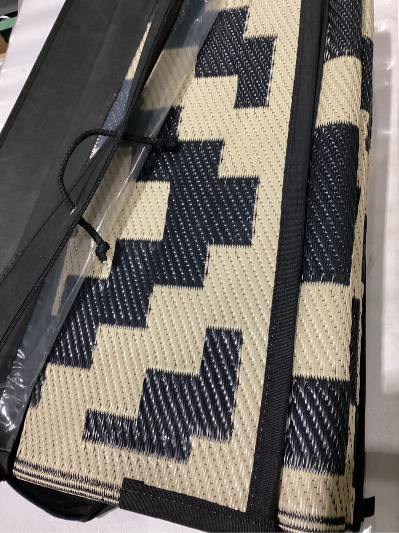 Condition photo showing New/Like New for Smiry Waterproof Outdoor Rug 8x10 ft, Reversible Plastic Straw Patio Camping Rugs, Outdoor Indoor RV Mat Carpet for Patio, Outside Entry, Backyard, Deck, Bench, Picnic, Camper, Black & Beige Black and Beige 8' x 10' (Rectangular)