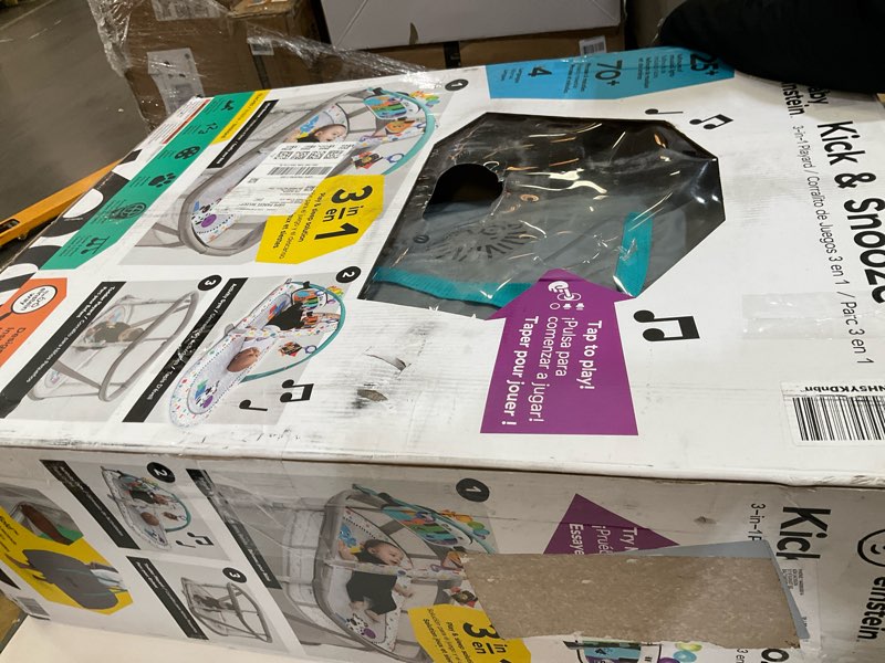 Condition photo showing As Is for baby einstein kick & snooze 3-in-1 foldable playard, bassinet and musical play gym, includes fitted sheet, 3-step easy fold, piano toy with 25+ minutes of music, grows with baby, ages 0 months and up