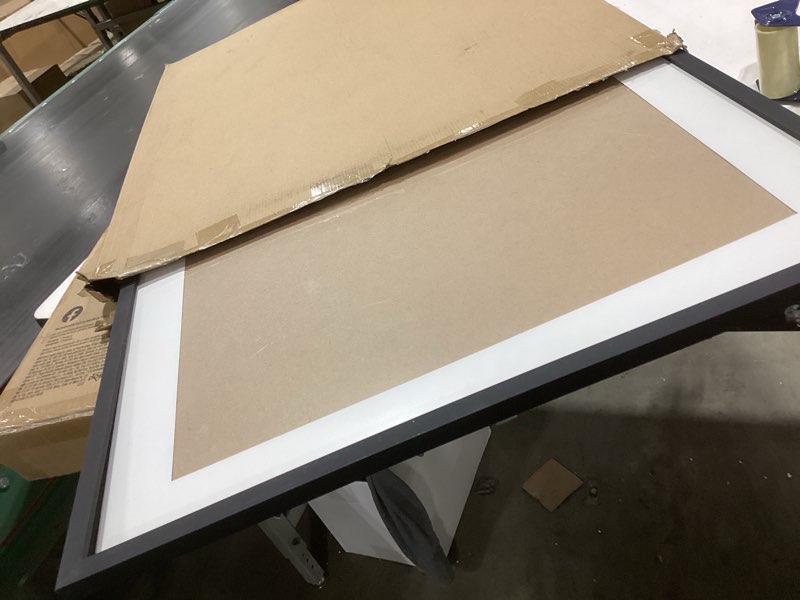 Condition photo showing As Is for Americanflat 24x32 Poster Frame with Polished Plexiglass - Use as 20x28 Frame with Mat or Display 24x32 Photo Without Mat - Streamline Collection - Thin Border Picture Frames for Wall - Black Black 24x32 1 Pack