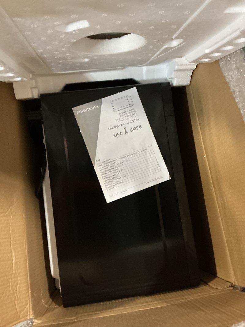 Condition photo showing As Is for FRIGIDAIRE EMW736BLK 0.7 Cu. Ft. Microwave, Black