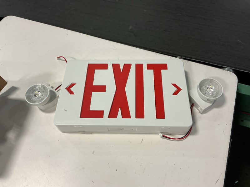 Condition photo showing Good Condition for gruenlich led combo emergency exit sign with 2 adjustable head lights and double face, back up batteries- us standard red letter emergency exit lighting, ul 924 qualified, 120-277 voltage, 1-pack