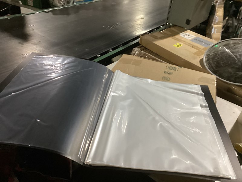 Condition photo showing As Is for large giant binder with plastic sleeves