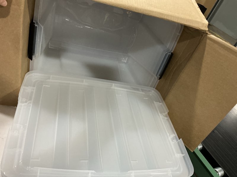 Condition photo showing As Is for iris usa 6-pack 54 quart storage bins with lids, clear | transparent design makes contents easy to find. perfect for moving, blankets, clothing, and garage storage. nestable design clear 54 qt 6 pack