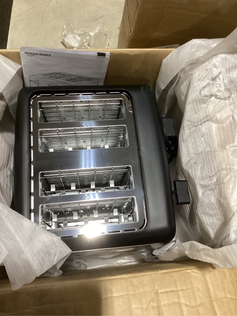 Condition photo showing Good Condition for amazon basics 4 slice toaster, with 7 browning settings, extra wide slots for bagels and special breads, removable easy-to-clean crumb trays, cancel/defrost/bagel buttons, 1500w, black & silver