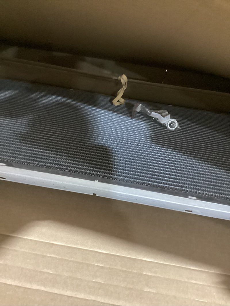Condition photo showing As Is for spectra premium cu2370 radiator with toc and eoc - 34-1/16" core compatible with chevrolet silverado, gmc and cadillac