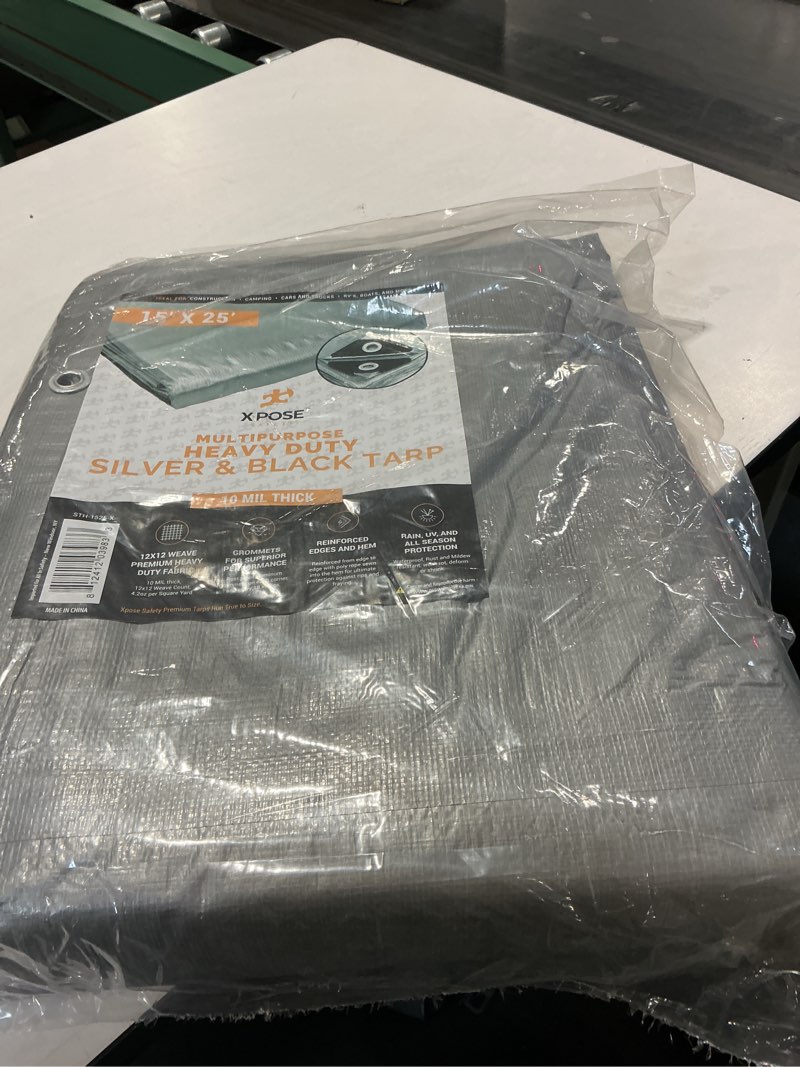Condition photo showing As Is for heavy duty poly tarp - 15' x 25' - 10 mil thick waterproof, uv blocking protective cover - reversible silver and black - laminated coating - grommets - by xpose safety silver/black 15 feet x 25 feet