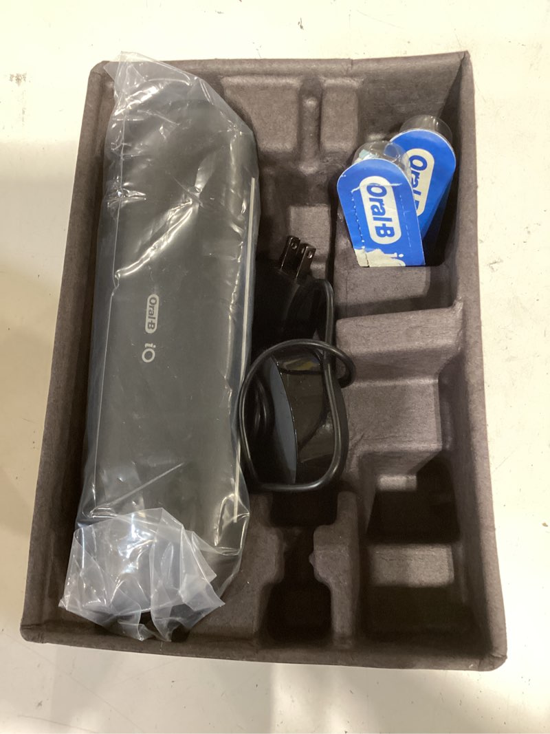 Condition photo showing Good Condition for oral-b rechargeable electric toothbrush, io9 limited ultimate clean, 7 cleaning modes, interactive display, isense charger, charging travel case, visible pressure sensor, 3 brush heads, black