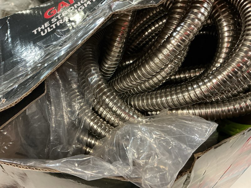 Condition photo showing As Is for flexible metal garden hose 100ft-heavy duty water hose with durable 304 stainless steel and 10 way spray nozzle-strong 3/4'' solid brass fitting-outdoor yard no kink lightweight long hose pipe