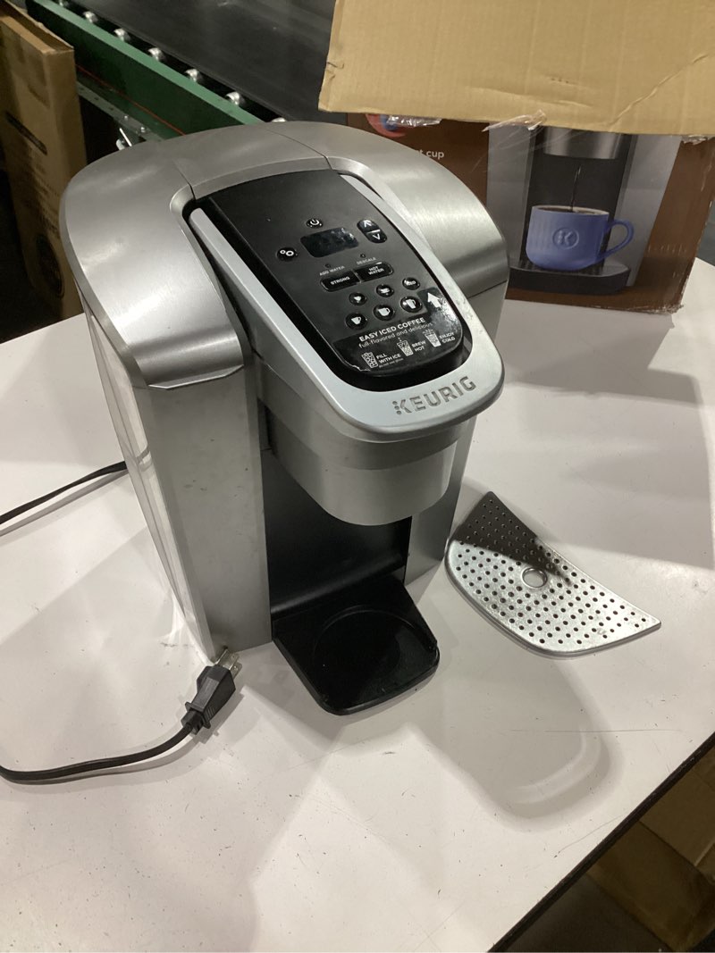 Condition photo showing As Is for **missing bottom tray*not tested**keurig k-elite single serve k-cup pod coffee maker, with strength and temperature control, iced coffee capability, 8 to 12oz brew size, programmable, brushed silver