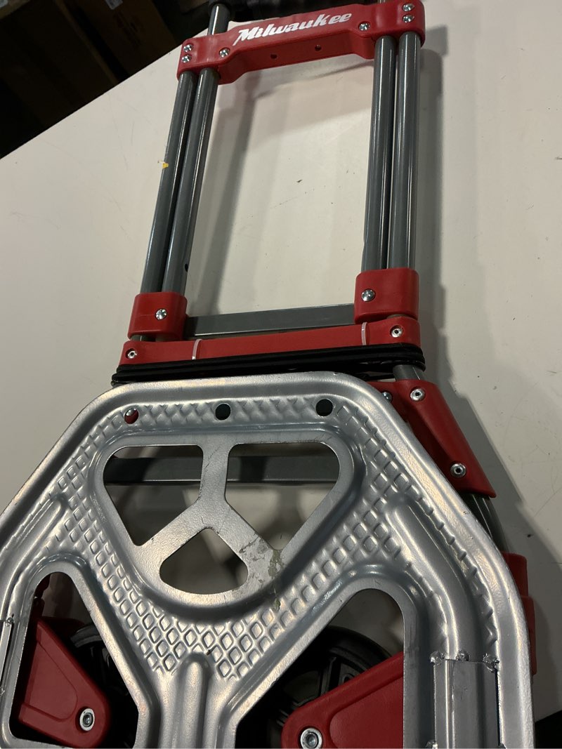 Condition photo showing As Is for 150 lbs. convertible fold-up steel hand truck with one 60 in. bungee cord