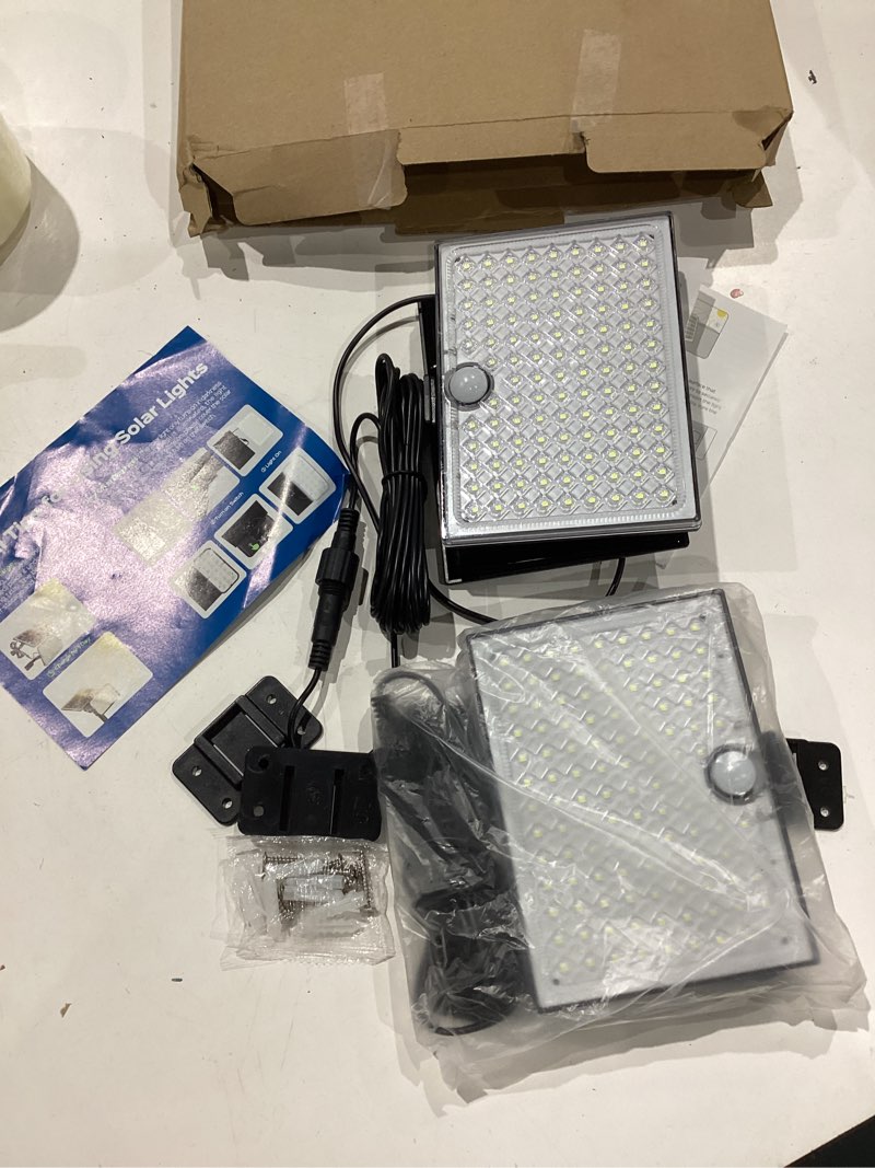 Condition photo showing Good Condition for superdanny solar outside lights with 113 bright leds 7000k, motion sensor outdoor flood lights dusk to dawn with 16ft cable ip65 waterproof, security light for garden barn porch 2 pack black 2 pack