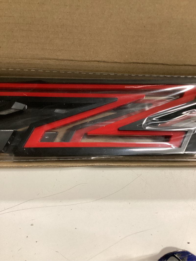 Condition photo showing Good Condition for 2pack 2019-2026 oem z71 emblems side left & right badges compatible with silverado tahoe suburban 84632695 (gloss black red) 2 black red