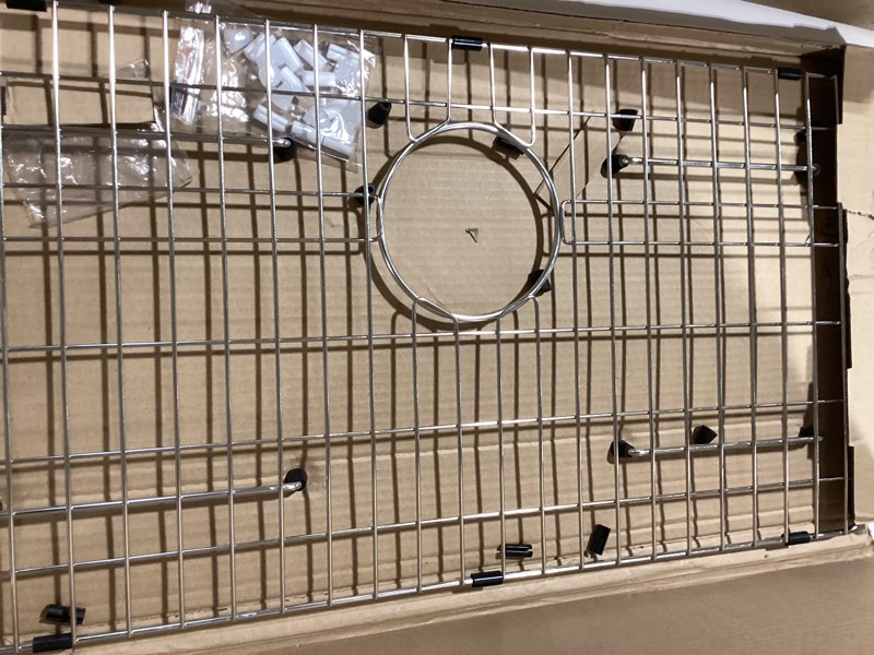 Condition photo showing Good Condition for stainless steel sink grid and protectors for bottom of kitchen sink, 26" x 14 1/16" sink bottom grid with rear drain for single sink bowl (26" x 14 1/16") 26" x 14 1/16" rear drain